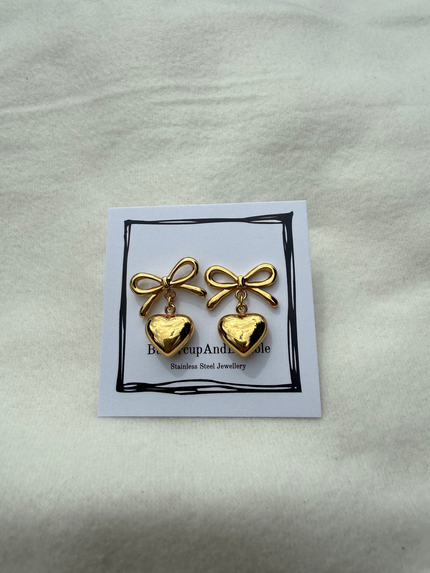 Gold bow and heart studs